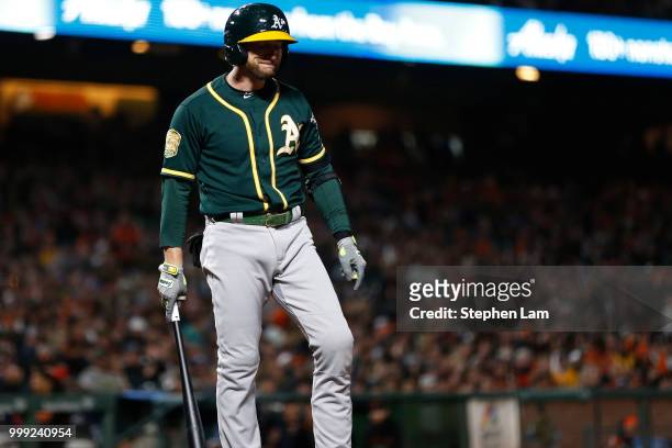 Jed Lowrie of the Oakland Athletics reacts after arguing a call with home plate umpire Vic Carapazza during the ninth inning against the San...