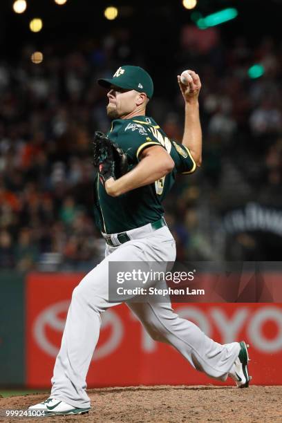 Blake Treinen of the Oakland Athletics delivers a pitch during the ninth inning against the San Francisco Giants at AT&T Park on July 14, 2018 in San...