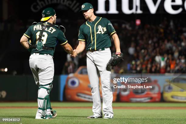 Blake Treinen of the Oakland Athletics shakes hands with catcher Josh Phegley after defeating the San Francisco Giants with a score of 4-3 at AT&T...