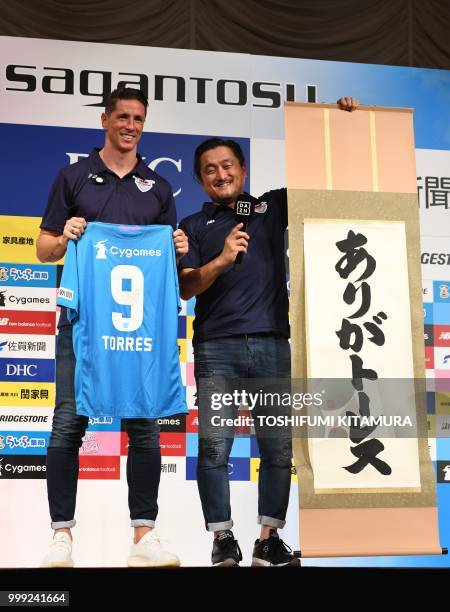 Spanish football star Fernando Torres and Sagan Dreams president Minoru Takehara pose together during a press conference welcoming Torres to the...