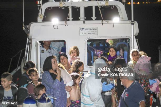 Some women with their children during landing stages of 75 Iraqi Kurdish refugees arrived in the port of Crotone after being intercepted by a patrol...