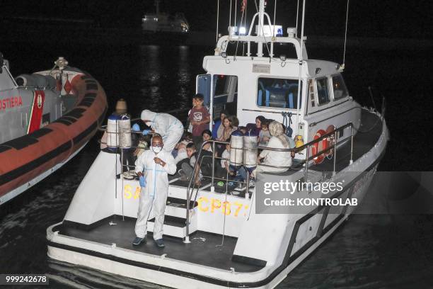 The landing stages of 75 Iraqi Kurdish refugees arrived in the port of Crotone after being intercepted by a patrol boat of the Guardia di Finanza 12...