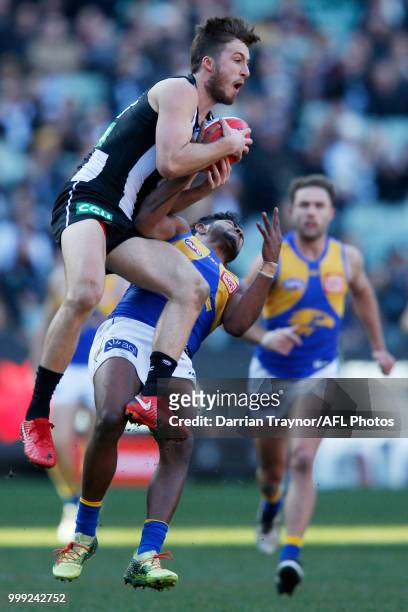 Tom Phillips of the Magpies and WIllie Rioli of the Eagles collide during the round 17 AFL match between the Collingwood Magpies and the West Coast...