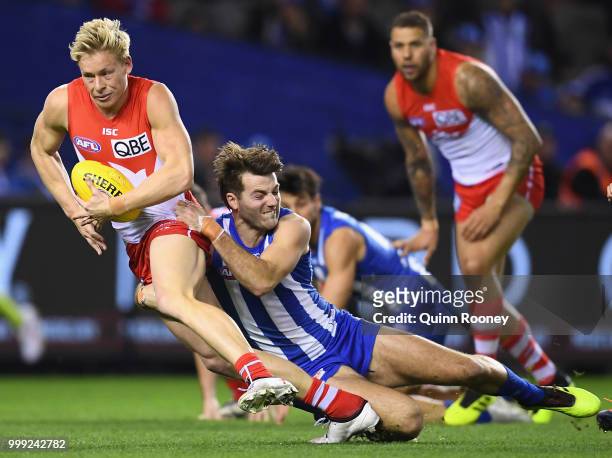 Isaac Heeney of the Swans is tackled by Luke McDonald of the Kangaroos during the round 17 AFL match between the North Melbourne Kangaroos and the...