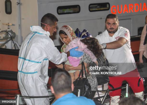 Woman with her child during landing stages of 75 Iraqi Kurdish refugees arrived in the port of Crotone after being intercepted by a patrol boat of...