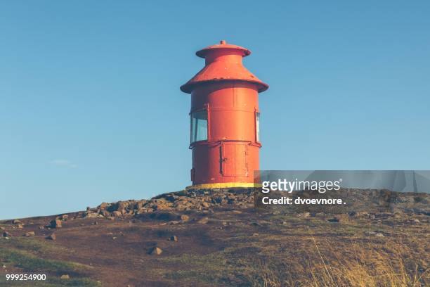 red lighthouse on a hill, iceland - red beacon stock pictures, royalty-free photos & images
