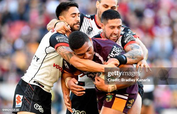 Patrick Mago of the Broncos is tackled during the round 18 NRL match between the Brisbane Broncos and the New Zealand Warriors at Suncorp Stadium on...