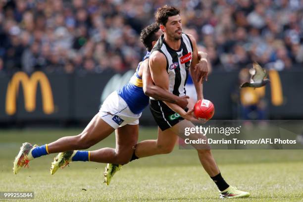 WIllie Rioli of the Eagles tackles Scott Pendlebury of the Magpies during the round 17 AFL match between the Collingwood Magpies and the West Coast...