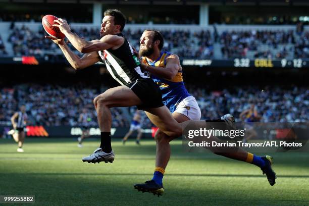 Levi Greenwood of the Magpies marks the ball during the round 17 AFL match between the Collingwood Magpies and the West Coast Eagles at Melbourne...