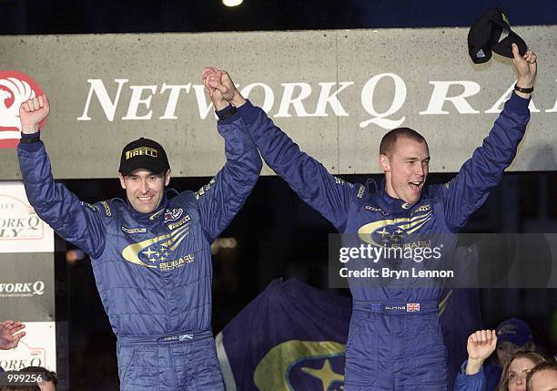 Richard Burns and co-driver Robert Reid of England and Subaru celebrate their World Championship victory and third place in the Network Q Rally of...