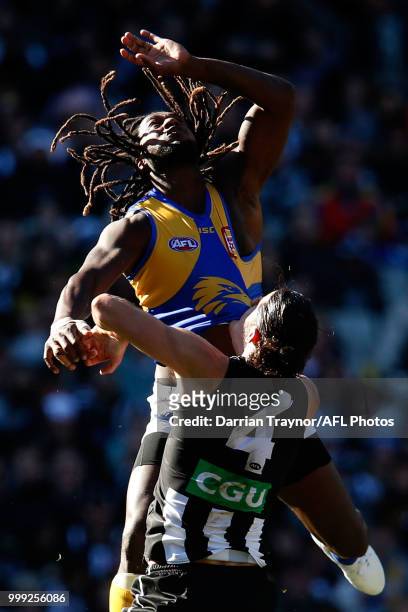 Nic Naitanui of the Eagles leaps over Brodie Grundy of the Magpies during the round 17 AFL match between the Collingwood Magpies and the West Coast...