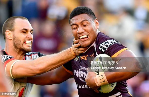 Patrick Mago of the Broncos takes on the defence of Simon Mannering of the Warriors during the round 18 NRL match between the Brisbane Broncos and...
