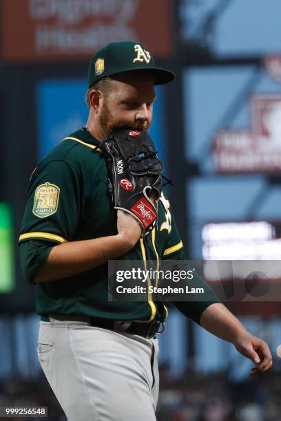 Pitcher Brett Anderson of the Oakland Athletics bites his gloves after he was relieved during the fourth inning against the San Francisco Giants at...