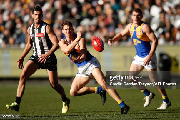 Jack Redden of the Eagles handballs during the round 17 AFL match between the Collingwood Magpies and the West Coast Eagles at Melbourne Cricket...