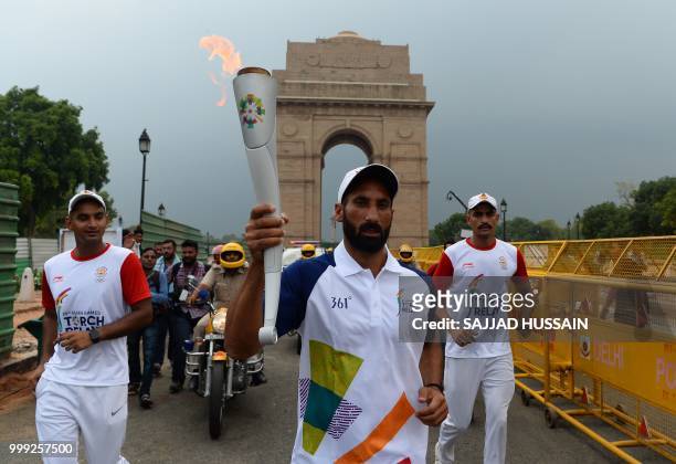 Former Indian hockey player Sardar Singh takes part in the 2018 Asian Games torch relay in New Delhi on July 15, 2018.