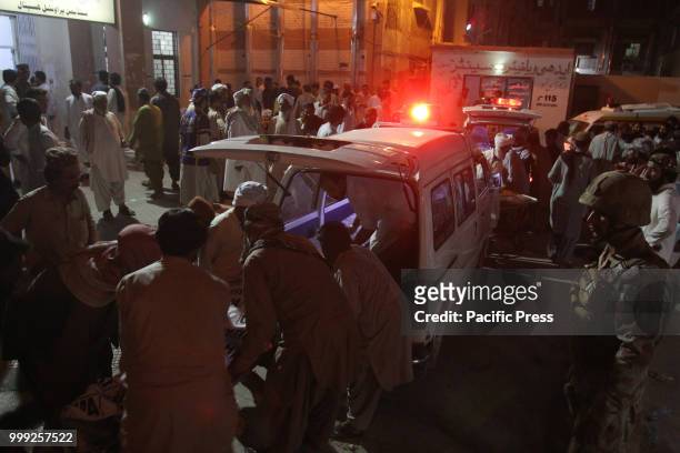 Rescue worker preparing to transport the injured and dead to a hospital. A suicide bombing attack on Balochistan Awami Party corner meeting at...