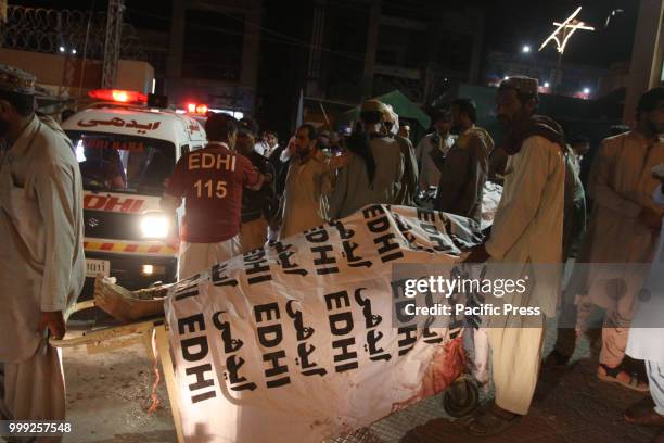 Rescue workers transport the dead bodies of victims to a hospital. A suicide bombing attack on Balochistan Awami Party corner meeting at Mastang...