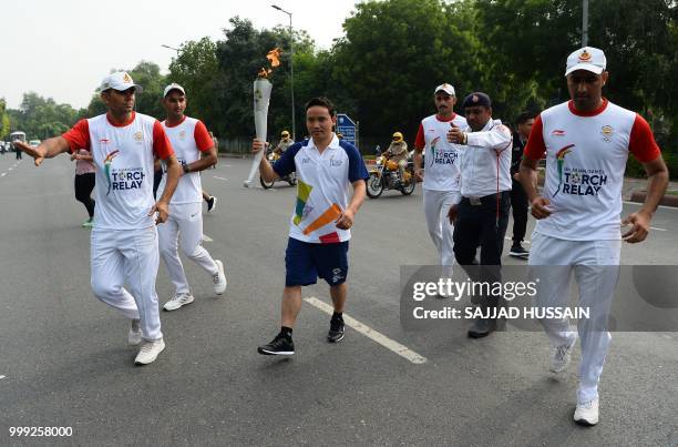 Indian shooter Jitu Rai takes part in the 2018 Asian Games torch relay in New Delhi on July 15, 2018.