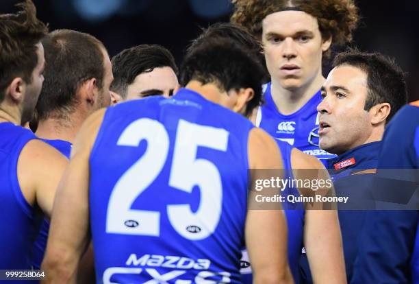 Kangaroos head coach Brad Scott talks to his players during the round 17 AFL match between the North Melbourne Kangaroos and the Sydney Swans at...