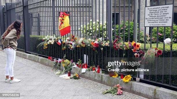 Woman looks at the symbols of condolence people have laid down in front of the Spanish embassy in Berlin, Germany, 21 August 2017. The mayor of...