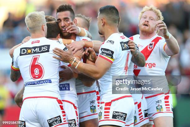 Ben Hunt of the Dragons celebrates with team mates after scoring a try during the round 18 NRL match between the St George Illawarra Dragons and the...