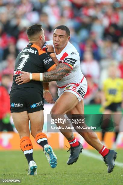 Luke Brooks of the Tigers is tackled by Tyson Frizell of the Dragons during the round 18 NRL match between the St George Illawarra Dragons and the...