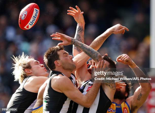 Darcy Moore of the Magpies, Levi Greenwood of the Magpies, Jeremy Howe of the Magpies and Josh Kennedy of the Eagles compete for the ball during the...