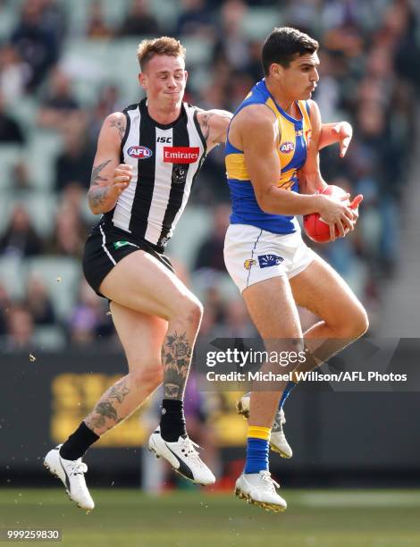 Ben Crocker of the Magpies and Tom Cole of the Eagles compete for the ball during the 2018 AFL round 17 match between the Collingwood Magpies and the...