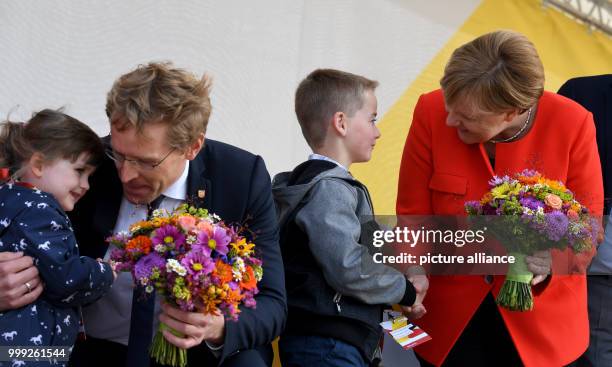 German Chancellor Angela Merkel on stage with little Felix at a CDU election campaign event in St.Peter-Ording, Germany, 21 August 2017. On the left...