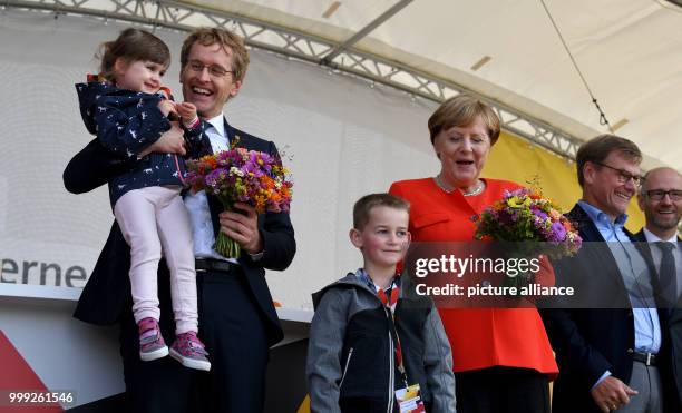 German Chancellor Angela Merkel on stage with little Felix at a CDU election campaign event in St.Peter-Ording, Germany, 21 August 2017. On the left...