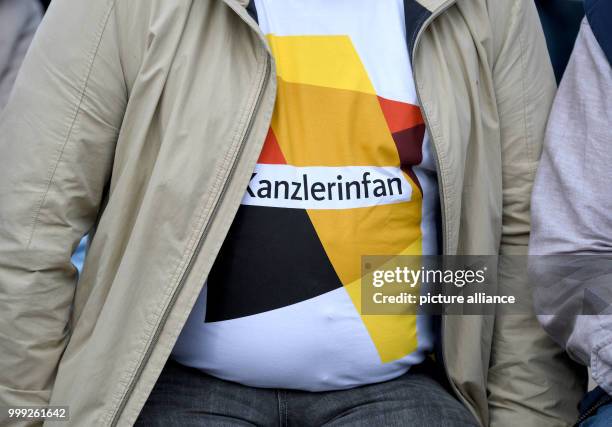 Person attending a CDU election campaign event with German Chancellor Angela Merkel wearing a t-shirt that reads "Kanzlerinfan" in St.Peter-Ording,...