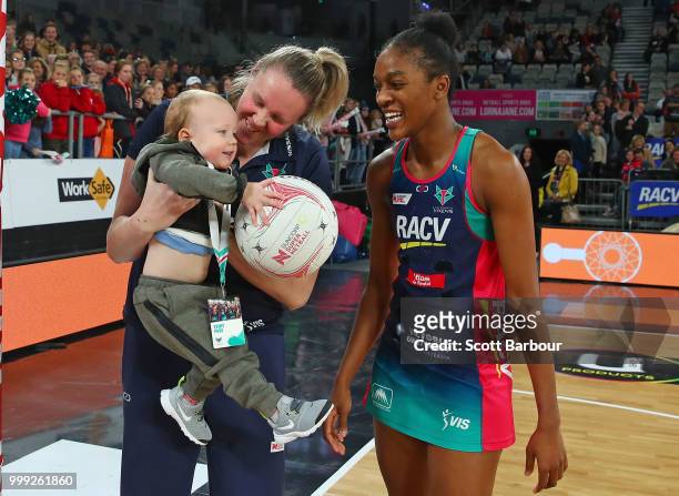 Emma Ryde of the Vixens holds Jacob Ingles up so he can shoot the ball as Kadie-Ann Dehaney looks on after the round 11 Super Netball match between...