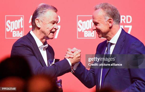 Soccer manager Karl-Heinz Rummenigge congratulates fellow manager Ottmar Hitzfeld on the latter's lifetime achievement award at the Sport Bild Awards...