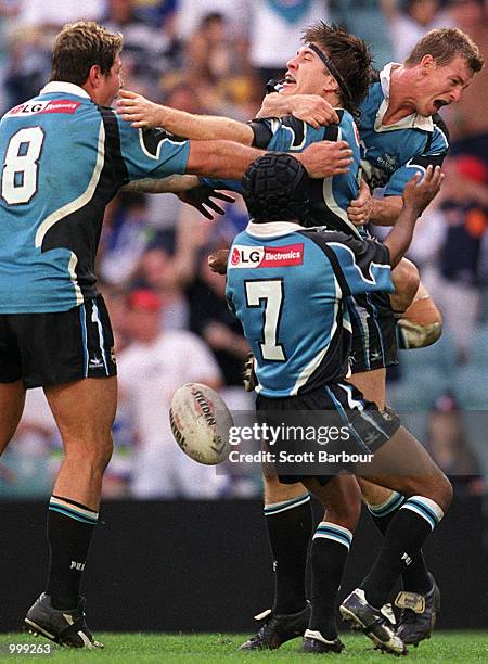 Martin Lang of the Sharks is congratulated by his team mates after scoring a try during the NRL second semi final match between the Bulldogs and the...