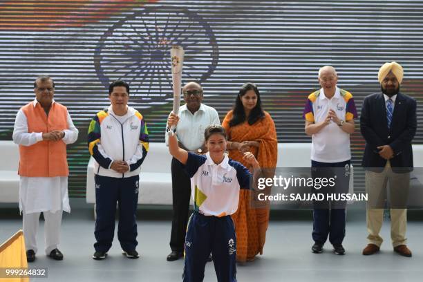 Indian boxer Mary Kom gestures as she takes part in the start of the 2018 Asian Games torch relay in New Delhi on July 15, 2018. - Indonesia will...