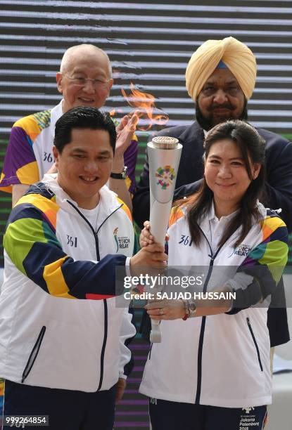 Former badminton player Susi Susanti , the Torch ambassador from Indonesia, and Indonesia Asian Games Organizing committee chairman Erick Thohir ,...