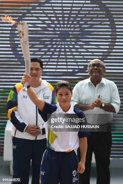 Indian boxer Mary Kom poses as she takes part in the start of the 2018 Asian Games torch relay in New Delhi on July 15, 2018. - Indonesia will host...