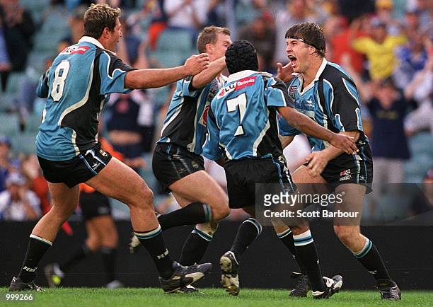 Martin Lang of the Sharks is congratulated by his team mates after scoring a try during the NRL second semi final match between the Bulldogs and the...