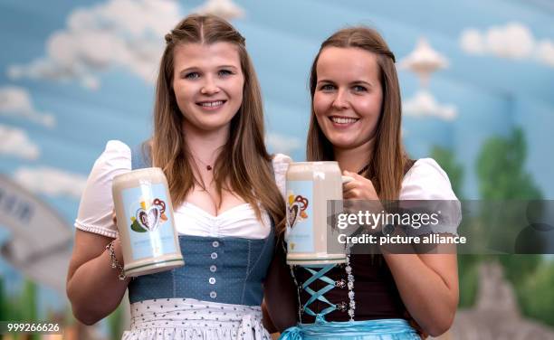 Isabelle and Sarah present the official Oktoberfest 2017 beer tankard at a press conference in Munich, Germany, 22 August 2017. The festival opens on...