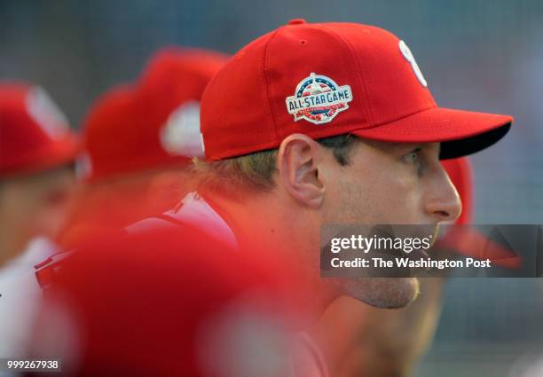 Washington starting pitcher Max Scherzer blows a bubble while sitting on the bench during the Washington Nationals defeat of the Miami Marlins 14 -12...