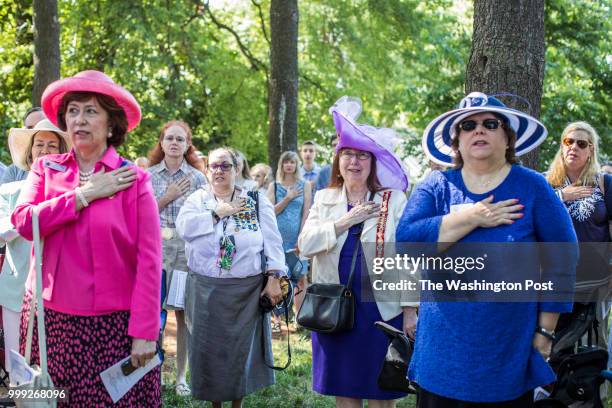 Women with the Daughters of the American Revolution say a prayer during the dedication ceremony of the Wren-Darne Cemetery on July 14, 2018 in Falls...