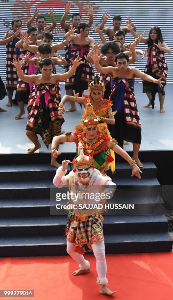 Artists from Indonesia perform before the 2018 Asian Games torch relay in New Delhi on July 15, 2018. - Indonesia will host the 2018 Asian Games from...