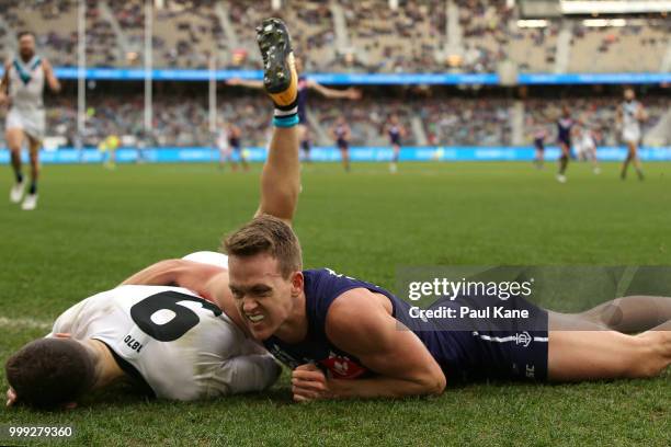 Ryan Nyhuis of the Dockers tackles Robbie Gray of the Power during the round 17 AFL match between the Fremantle Dockers and the Port Adelaide Power...