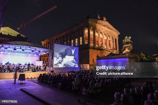 Numerous people following the inauguration of the UFA Film Night in the in the Kolonnadenhof in the Museums Island in Berlin, Germany, 22 August...