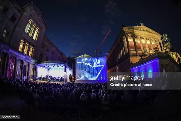 Numerous people following the inauguration of the UFA Film Night in the in the Kolonnadenhof in the Museums Island in Berlin, Germany, 22 August...
