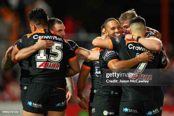 Tigers players celebrate after full time after winning the round 18 NRL match between the St George Illawarra Dragons and the Wests Tigers at UOW...