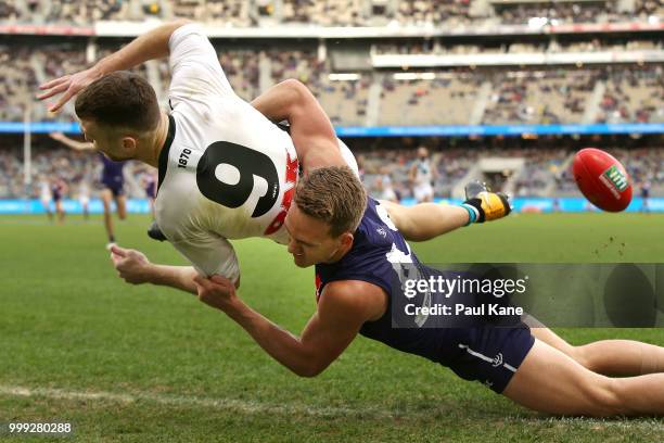 Ryan Nyhuis of the Dockers tackles Robbie Gray of the Power during the round 17 AFL match between the Fremantle Dockers and the Port Adelaide Power...