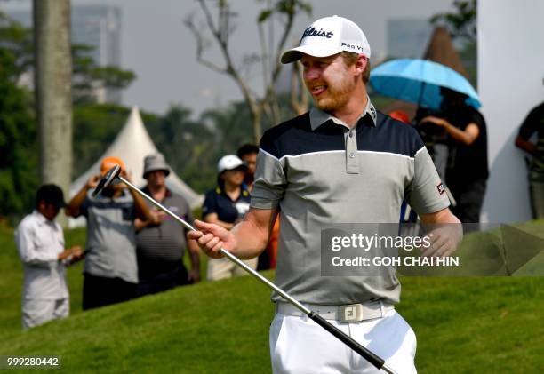 Justin Harding of South Africa reacts after putting in to win the Indonesia Open golf tournament at the Pondok Indah Golf Course in Jakarta on July...