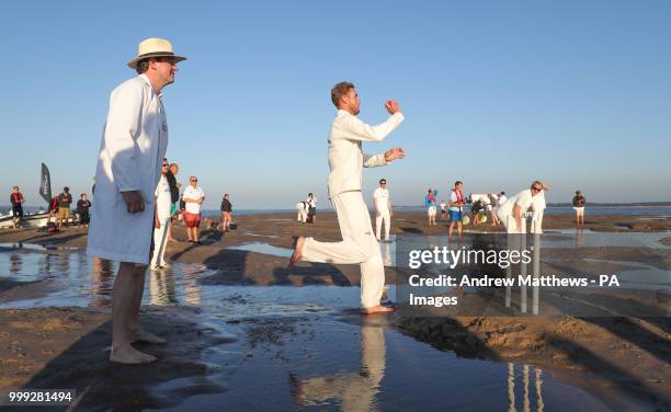 Miles Jupp , acting as umpire looks on as Stuart Broad runs in to bowl for the Royal Southern Yacht Club during their annual Bramble Bank cricket...