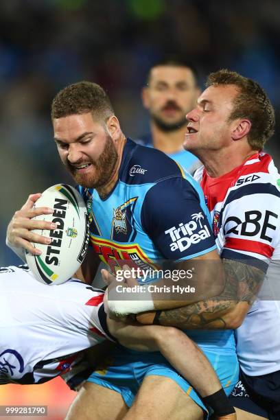 Brenko Lee of the Titans is tackled during the round 18 NRL match between the Gold Coast Titans and the Sydney Roosters at Cbus Super Stadium on July...